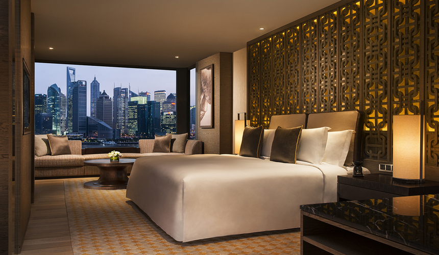 A luxury riverside hotel offering spa services, fine dining, and panoramic views of the Huangpu River and city skyline.