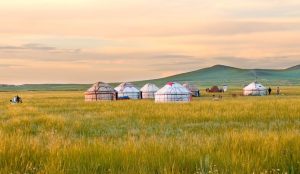 Mongolian yurts on green grasslands under a blue sky in Inner Mongolia