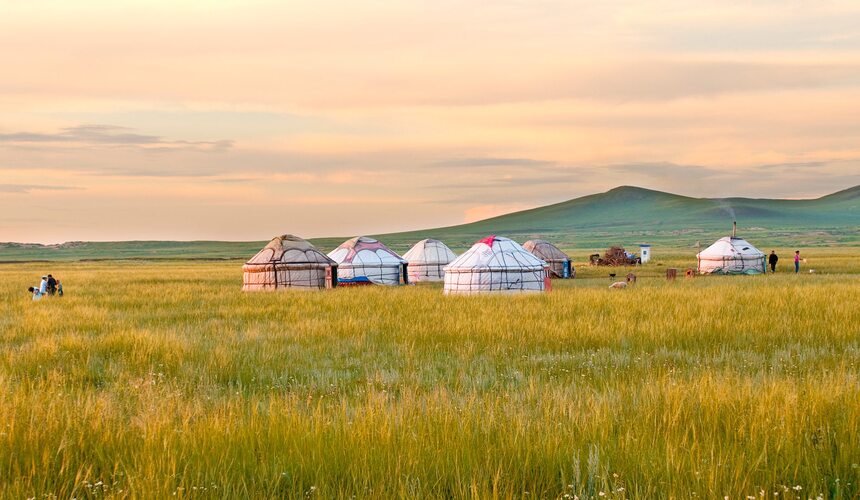 Mongolian yurts on green grasslands under a blue sky in Inner Mongolia