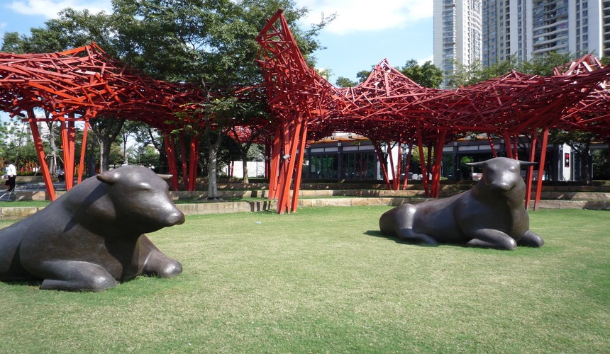 A contemporary outdoor park featuring large sculptures and green space in the heart of Shanghai.