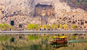 Thousands of ancient Buddhist statues and carvings etched into limestone cliffs along the Yi River.