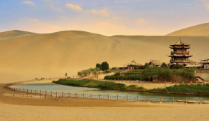Colorful layers of the Zhangye Danxia landform in Gansu Province under a bright blue sky.