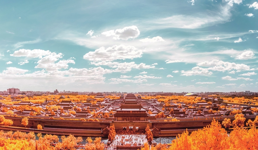 Aerial view of the Forbidden City’s grand palace complex and ancient red walls in Beijing.