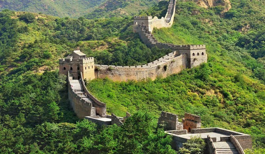 Majestic section of the Great Wall of China near Beijing winding over green mountains under a clear sky. Let me know if you want variations for different sections like Mutianyu or Badaling.