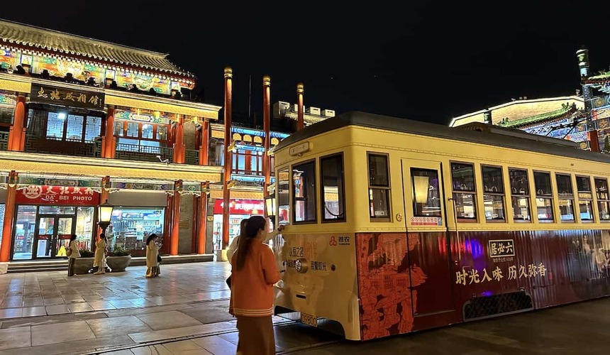 Panoramic view of central Beijing with traditional rooftops and modern city skyline.