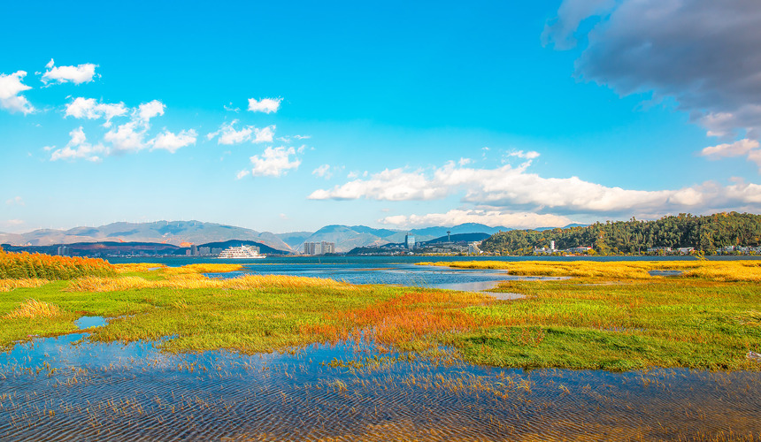 Peaceful lakeside view with Cangshan Mountains in the background at Erhai Lake near Dali, Yunnan