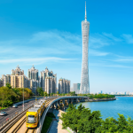 Modern skyline of Guangzhou featuring the Canton Tower and Pearl River at dusk