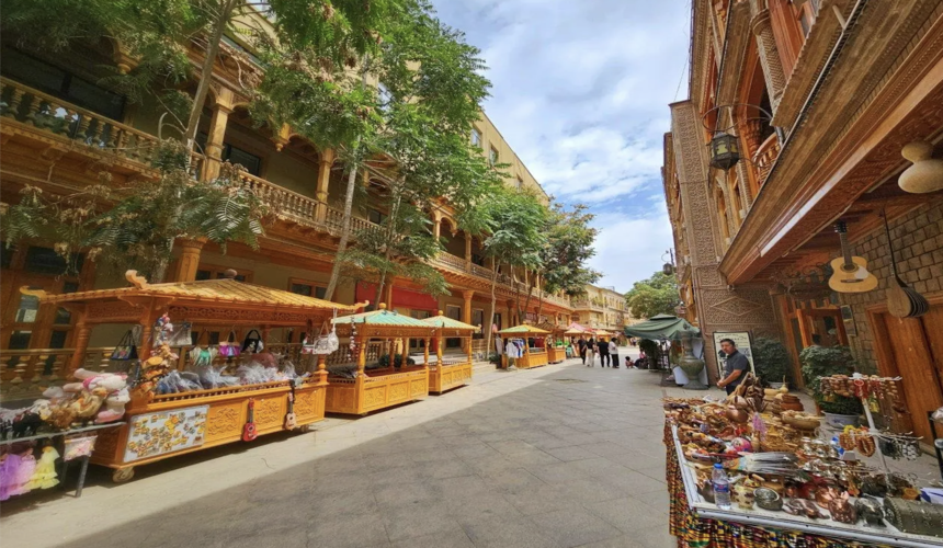 Busy and colorful scene of Hotan Night Market with local Uyghur food and handmade crafts