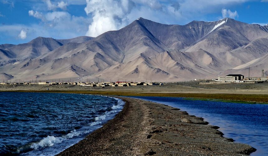 Stunning view of Karakul Lake with snow-capped mountains in the background near the China-Pakistan border