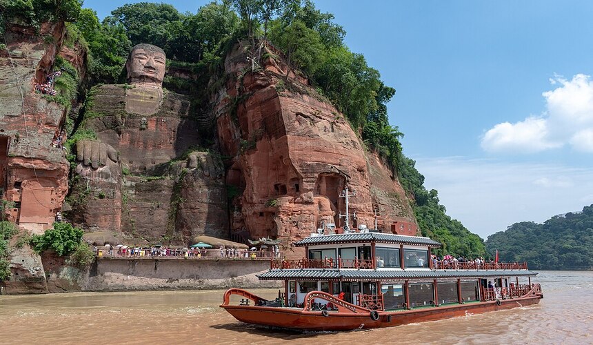 Misty forest trails of Mount Emei and the massive seated Leshan Giant Buddha carved into a cliff
