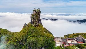 Dramatic rocky peak and mountaintop temple at Mount Fanjing, Guizhou Province.