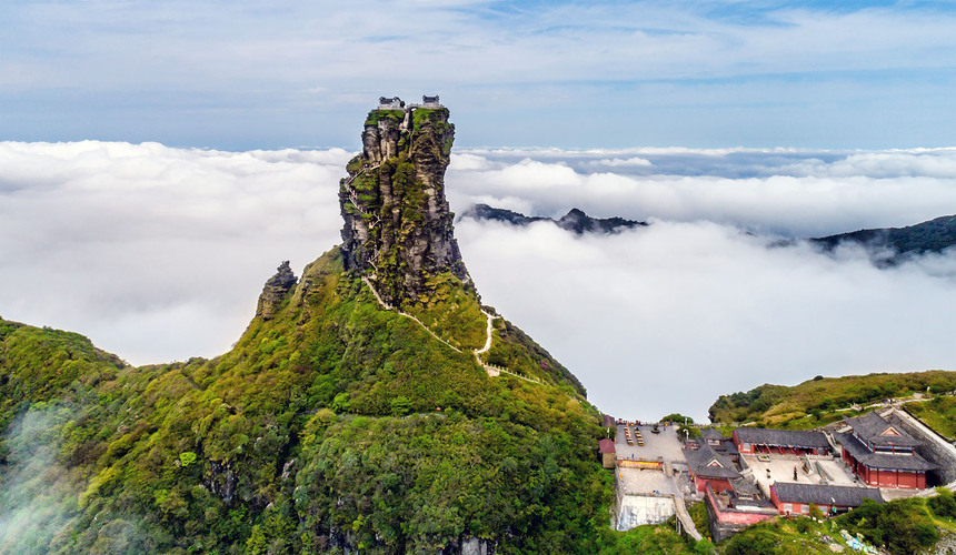 Dramatic rocky peak and mountaintop temple at Mount Fanjing, Guizhou Province.