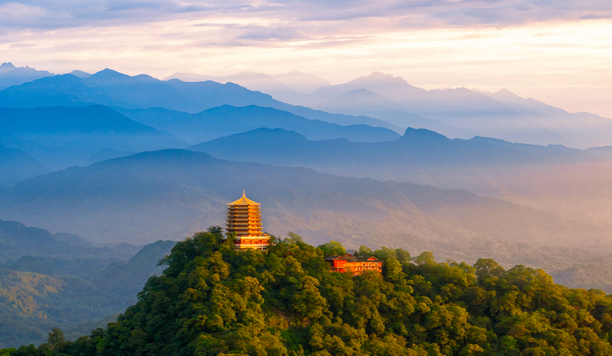 Lush, mist-covered forest and ancient Taoist temple on Mount Qingcheng, Sichuan Province.