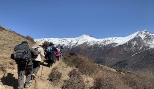 Climbers ascending a snow-covered peak in Siguniang Mountains, Sichuan