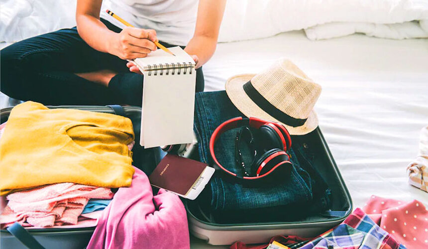 Laid-out summer clothes, hat, and travel gear for a trip to China