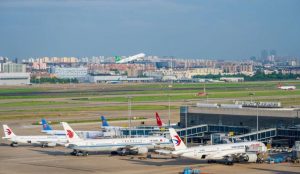 Interior view of Shanghai Pudong International Airport with modern architecture and travelers.