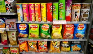 Variety of colorful Chinese snacks including dried fruits, seaweed chips, and candies