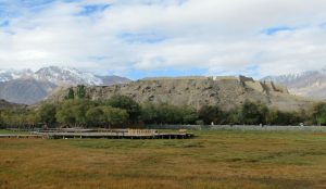 Ancient stone walls of Tashkurgan Fort set against the backdrop of Pamir Mountains in Xinjiang, China