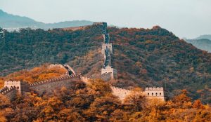Scenic stretch of the Great Wall winding through forested hills at Mutianyu near Beijing