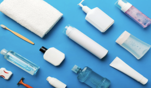 Travel-sized toiletries, medications, and hand sanitizer organized in a clear pouch