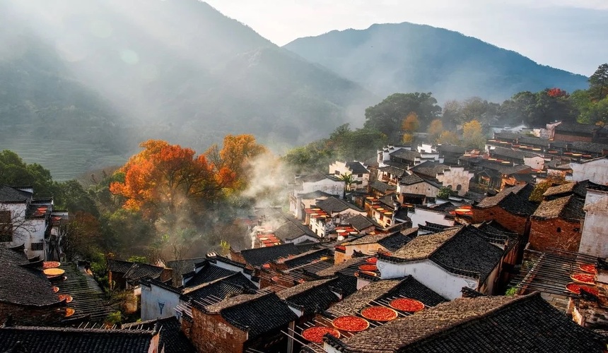 Charming traditional houses and yellow rapeseed flowers in Wuyuan Village, Jiangxi Province