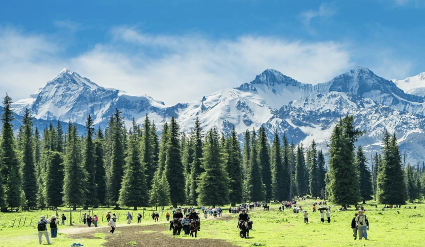 Seasonal weather in Xinjiang showing a mix of desert, snow-capped peaks, and grasslands