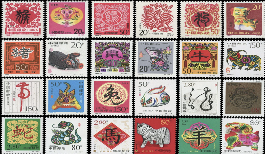 Chinese postage stamps displayed at a local post office or souvenir shop counter.