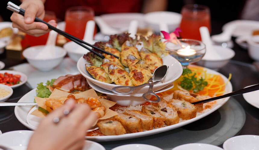 Chinese family sharing meal at round table showing dining etiquette in China