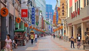 Bustling Beijing Road Pedestrian Street in Guangzhou with shops and neon signs
