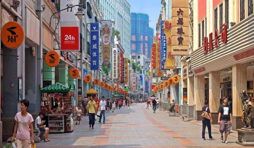 Bustling Beijing Road Pedestrian Street in Guangzhou with shops and neon signs