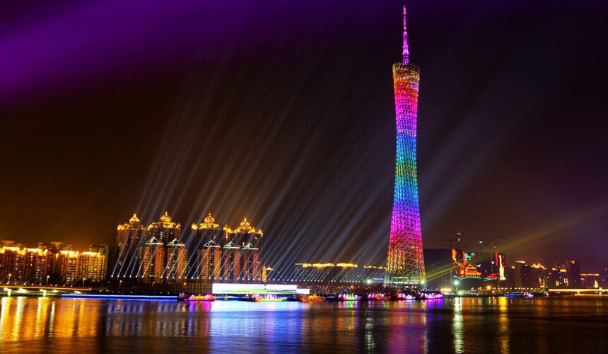Canton Tower in Guangzhou illuminated at night beside the Pearl River