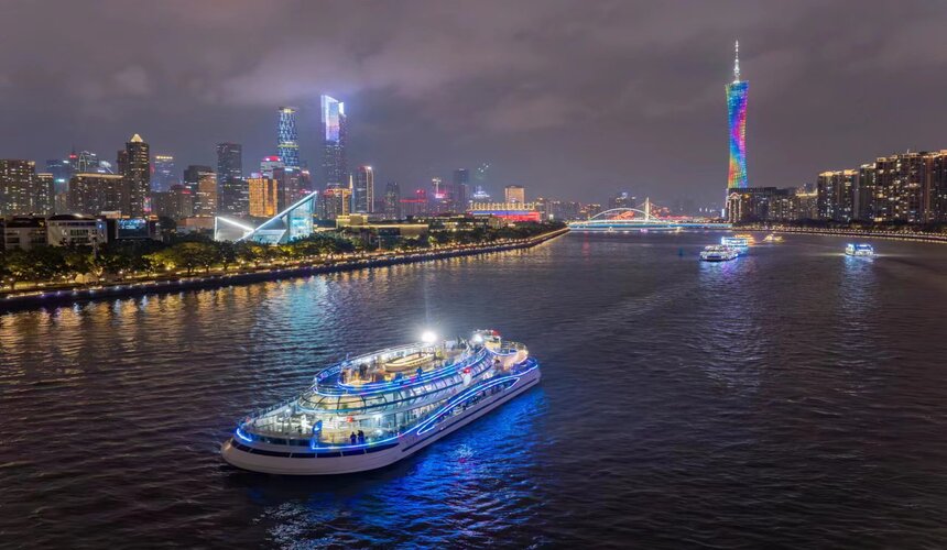 Colorful lights reflecting on the Pearl River during a night cruise in Guangzhou