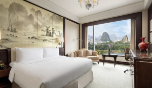 Luxury riverside Shangri-La Hotel in Guilin with mountain backdrop.