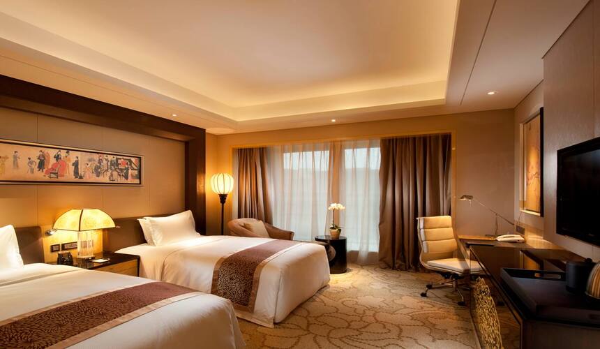 Modern Hilton Xi’an hotel building with bright night lights