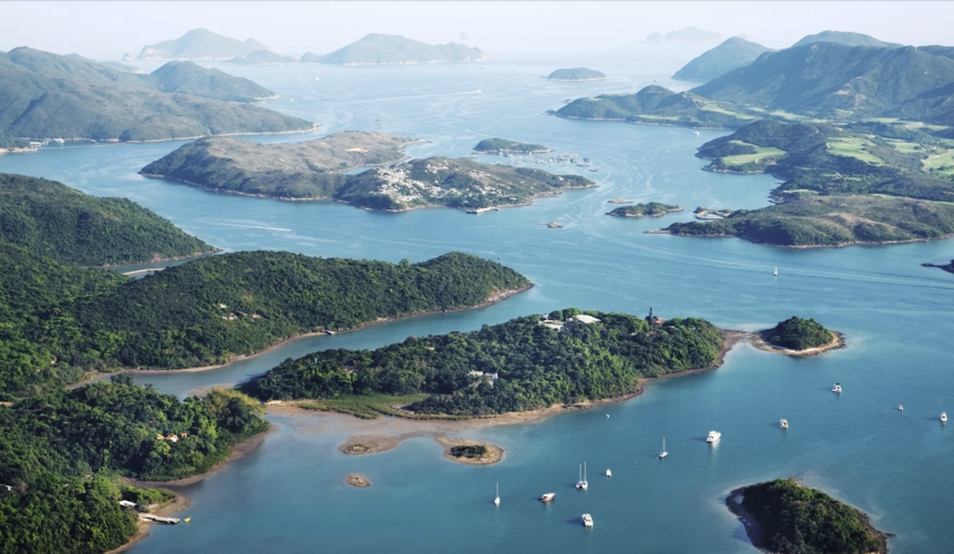 Tranquil fishing village scene on Hong Kong’s outlying islands with boats and stilt houses.