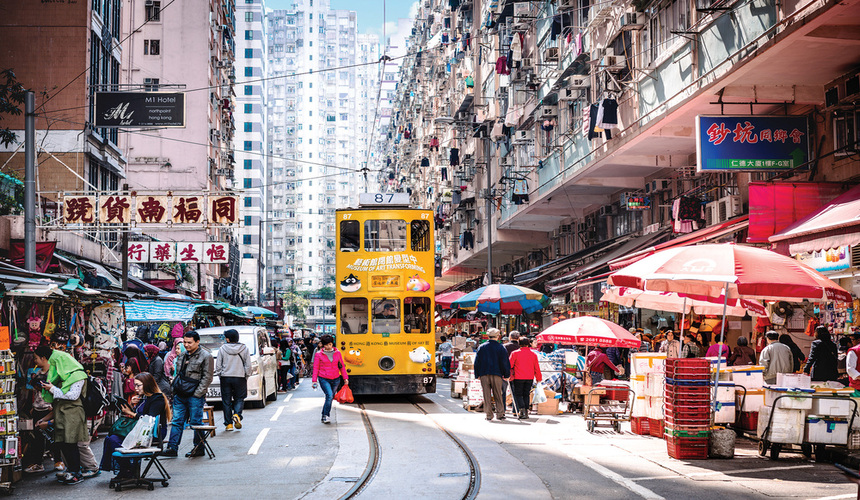 Scenic skyline view of Hong Kong with Victoria Harbour and high-rise buildings.