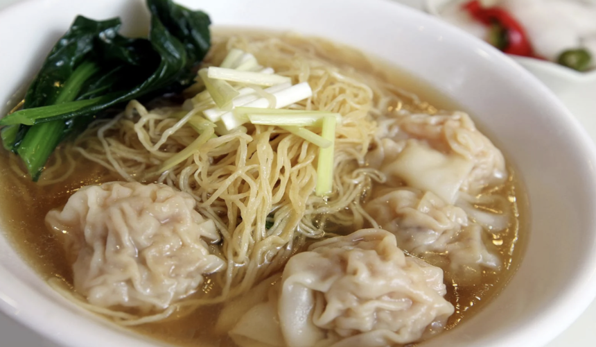 Bowl of Hong Kong-style wonton noodles in clear broth with prawns.