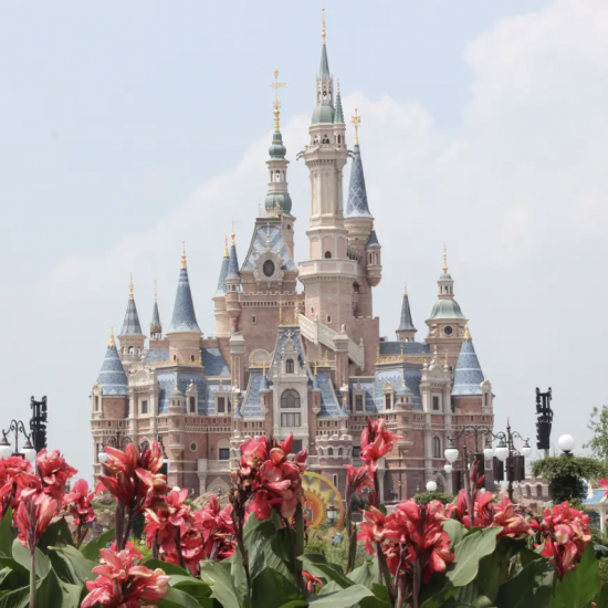 A view of Shanghai Disneyland's iconic Enchanted Storybook Castle, set against a vibrant sky in China.