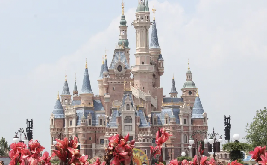 A view of Shanghai Disneyland's iconic Enchanted Storybook Castle, set against a vibrant sky in China.