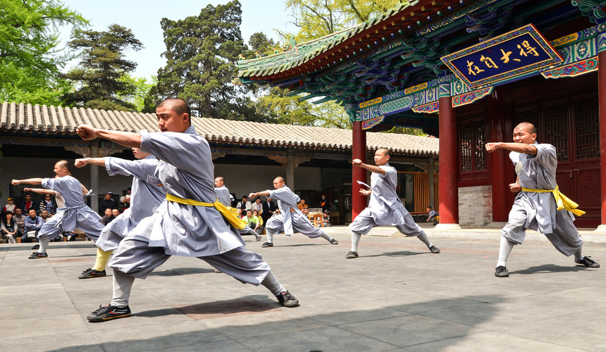 Kung Fu lessons in China with martial arts masters demonstrating traditional moves.