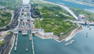 The Yangtze River winding through the Three Gorges with autumn foliage on steep cliffs in Yichang.