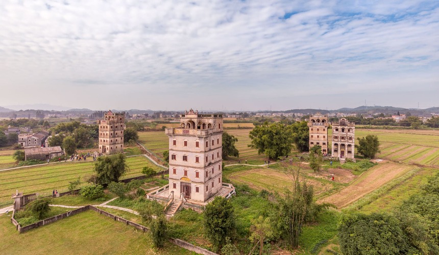 Historic multi-story watchtowers blending Chinese and Western architectural styles.