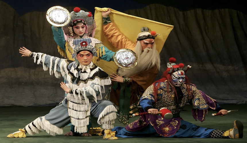 Peking Opera performance in Beijing featuring colorful costumes, dramatic makeup, and traditional Chinese singing and acting.