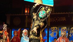 Sichuan Opera performance in Chengdu highlighting the famous face-changing art with vibrant masks and dramatic movements.