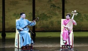 Pingtan storytelling performance in Suzhou with musicians narrating traditional tales using string instruments.