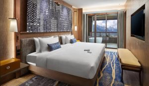 Traditional-style Club Med Lijiang resort with Jade Dragon Snow Mountain backdrop in Yunnan, China.