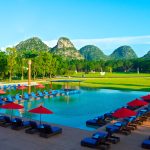 Luxury Club Med Guilin resort set beside tranquil lakes and dramatic karst mountains surrounded by lush greenery in Guangxi, China.