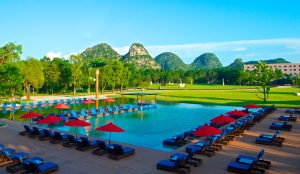 Luxury Club Med Guilin resort set beside tranquil lakes and dramatic karst mountains surrounded by lush greenery in Guangxi, China.