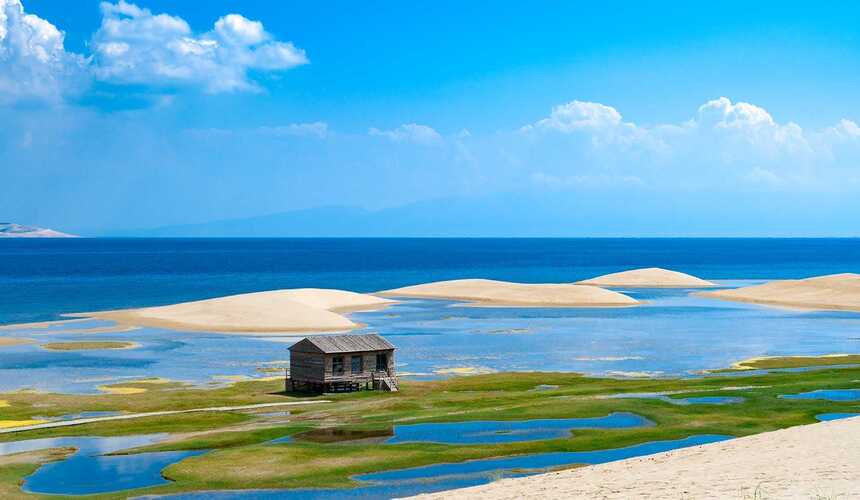 Qinghai Lake with snow-capped mountains in western China during spring