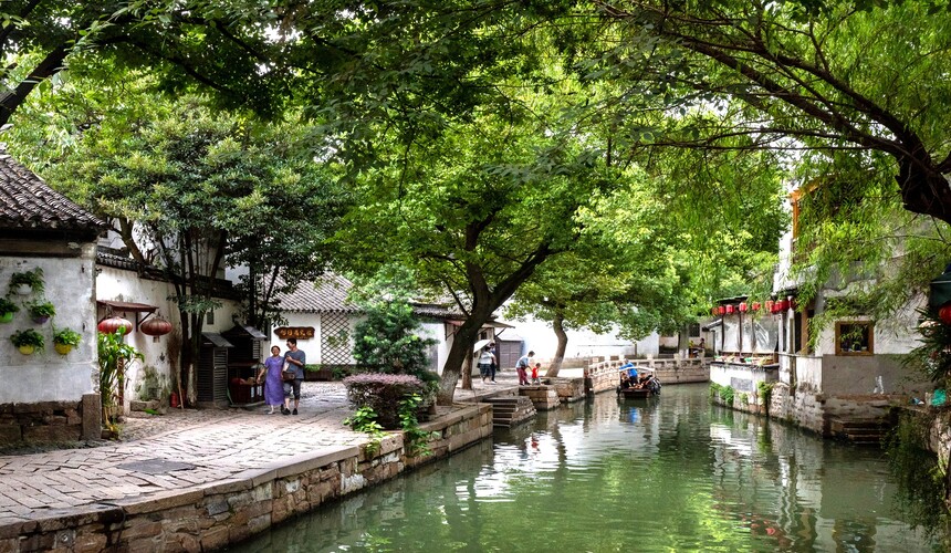 Peaceful canals, arched bridges, and classical gardens in Tongli water town, Jiangsu province.